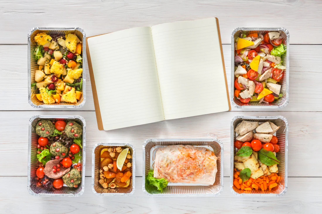 Bright produce arranged beside grains on a neutral tabletop.